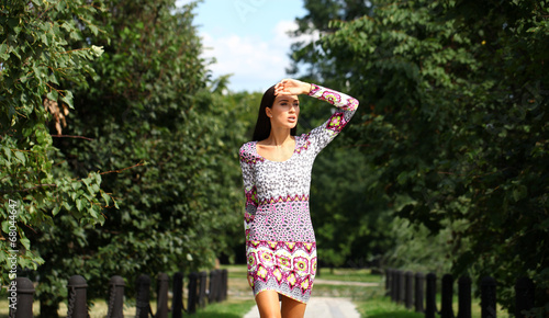 Beautiful young woman in colorful dress