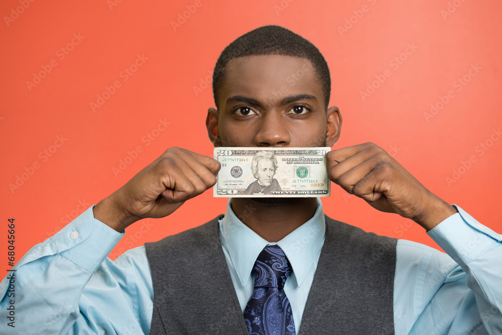 Bribery man with dollar bill on his mouth on red background Bribery man with dollar bill on his mouth on red background