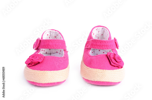 Pink baby sneakers on white background