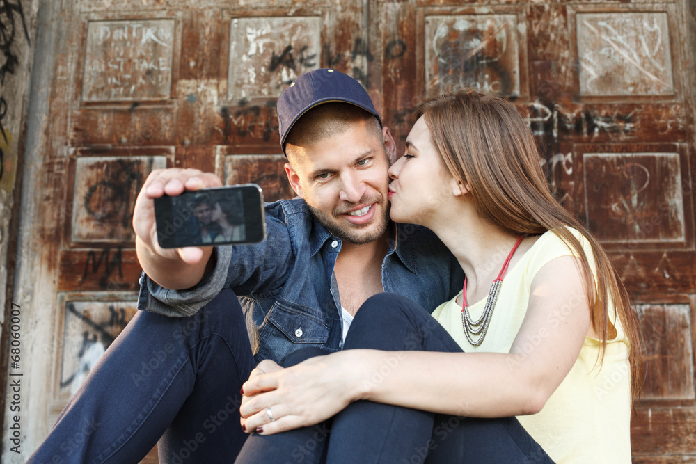 Young couple in embrace takes selfie Young couple in embrace takes selfie