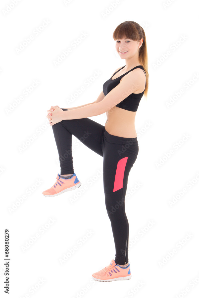 attractive teenage girl in sports wear stretching leg isolated o