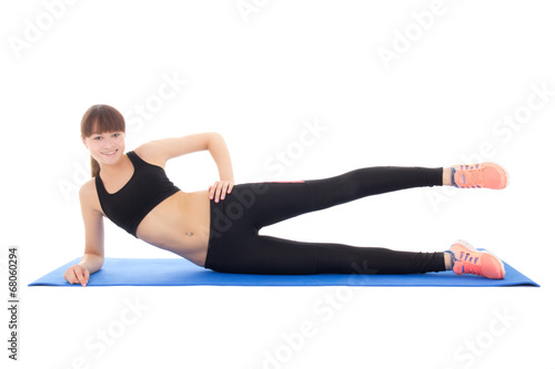 smiling teenage girl doing fitness exercises on a mat isolated o