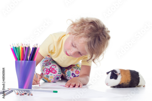 Cute blonde girl drawing with colored pencils