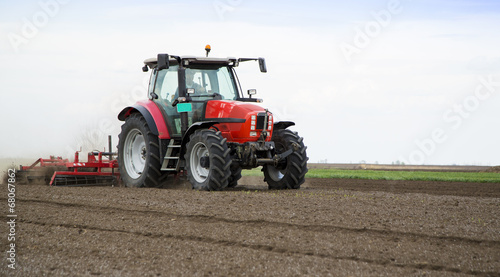 Preparing land for sowing at spring  farmer in tractor