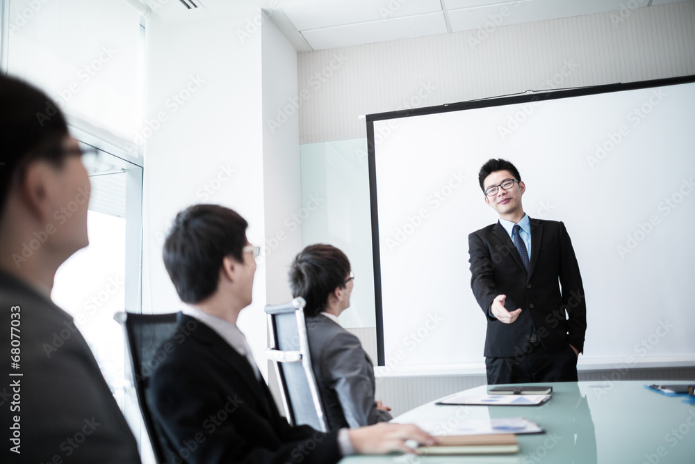 businessman giving a presentation to his colleagues businessman giving a presentation to his colleagues