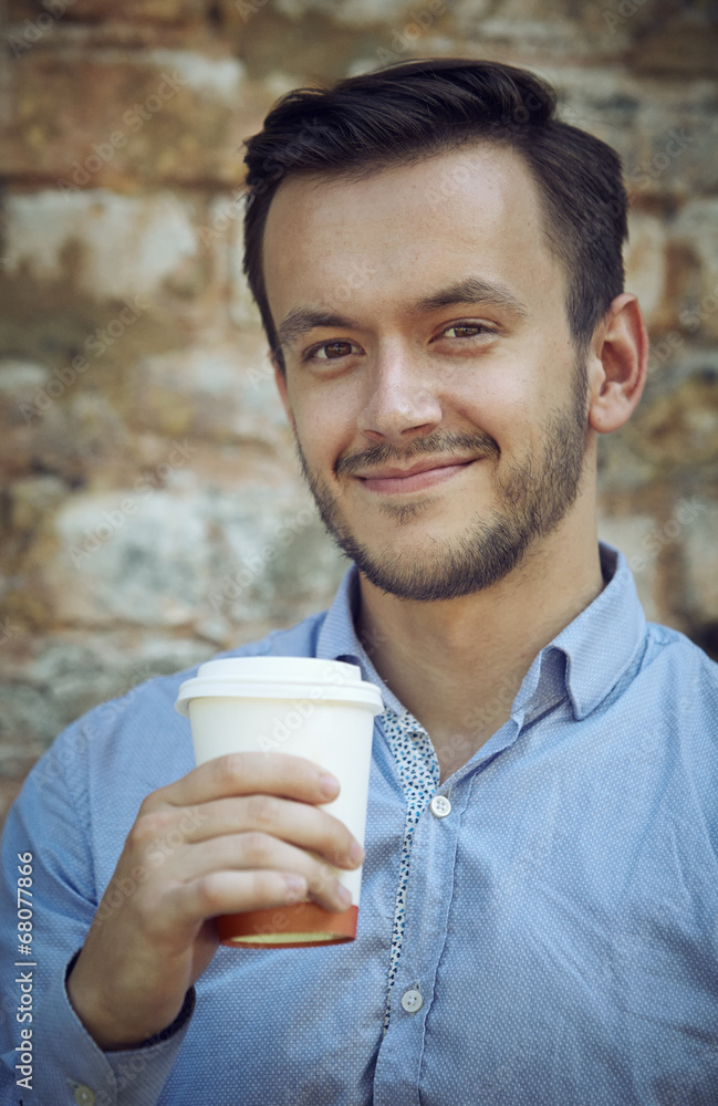 young man with cup of coffee young man with cup of coffee