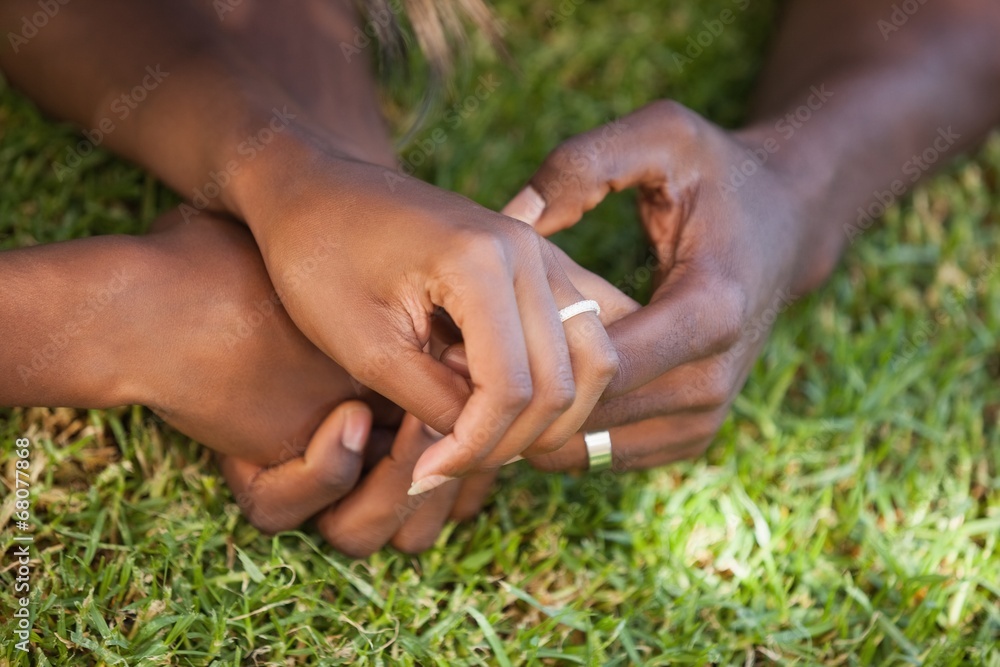 Couple holding hands on the grass Couple holding hands on the grass