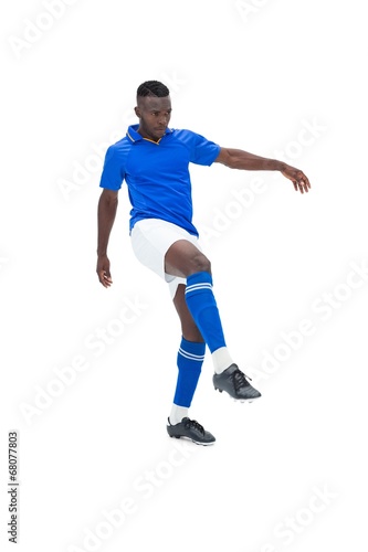 Football player in blue kicking © WavebreakmediaMicro