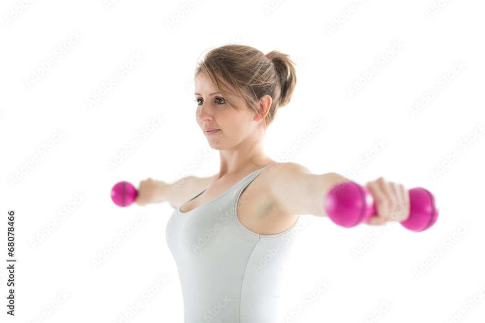 Young woman exercising with dumbbells Young woman exercising with dumbbells