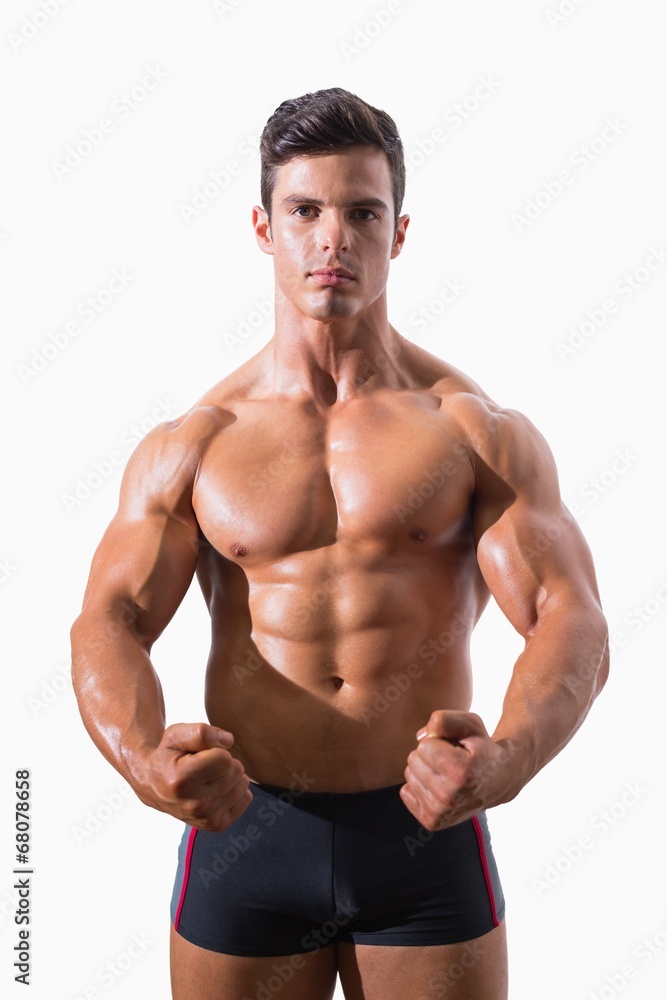 Portrait of a muscular man clenching fists Portrait of a muscular man clenching fists