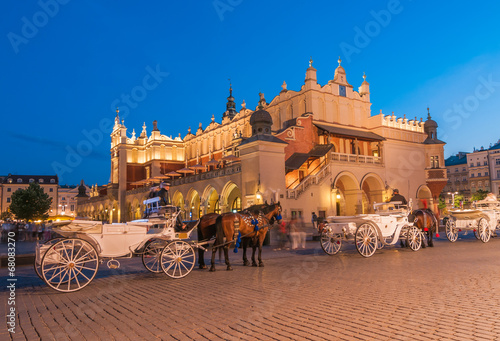 Carriages before the Sukiennice on The Main Market in Krakow photo