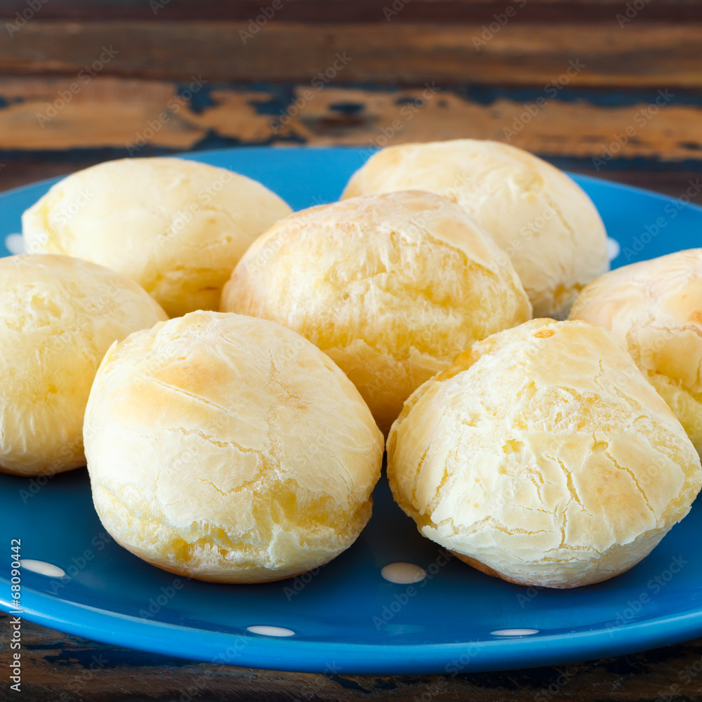 Brazilian snack cheese bread (pao de queijo) on blue plate Brazilian snack cheese bread (pao de queijo) on blue plate
