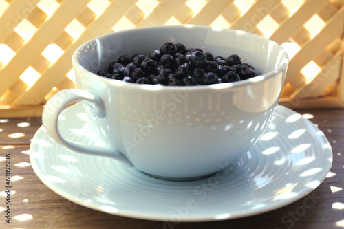 Useful blueberry in bowl on table, close-up