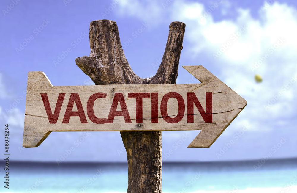 Vacation wooden sign with a beach on background