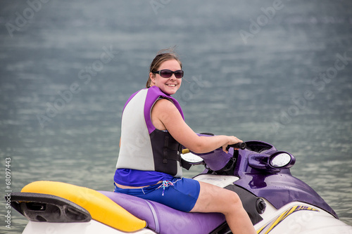 Young Woman piloting a personal water craft