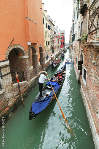 ourists floating in gondola in canal in Venice © vvoe