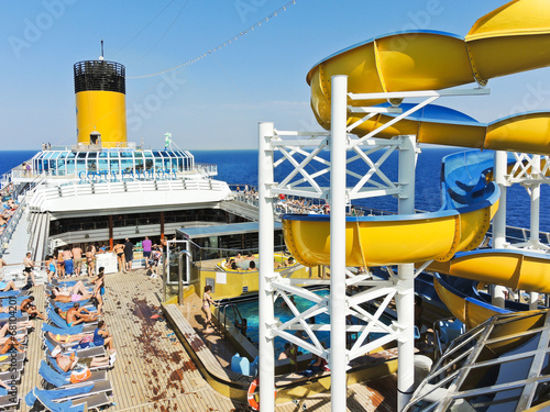 many tourists relaxing on the deck of cruise liner