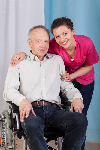 Nurse standing by the disabled in a wheelchair