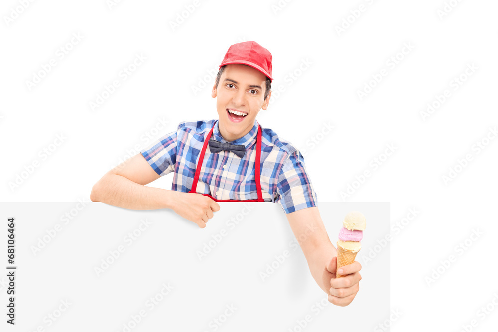 Male vendor holding an ice cream behind a panel Male vendor holding an ice cream behind a panel