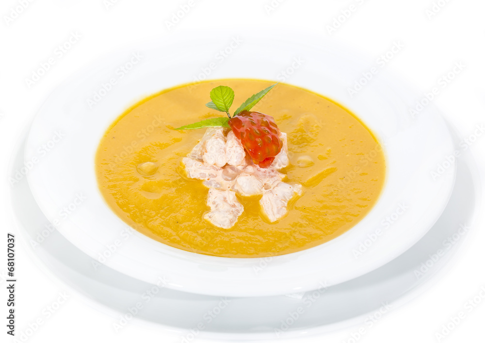 Pumpkin soup with shrimp and tomato on a white background Pumpkin soup with shrimp and tomato on a white background