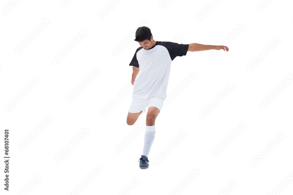 Football player in white kicking