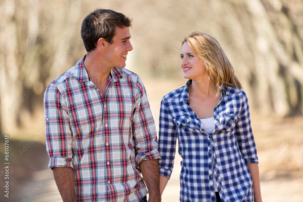 young couple enjoying a walk in fall young couple enjoying a walk in fall