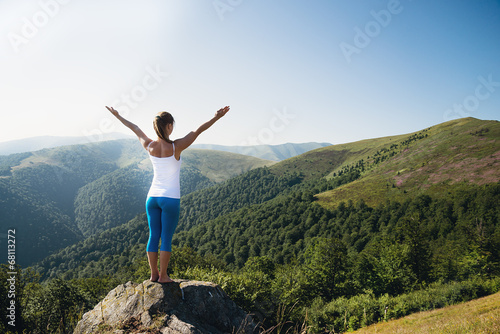 Young woman meditate on the top of mountain © nickolya