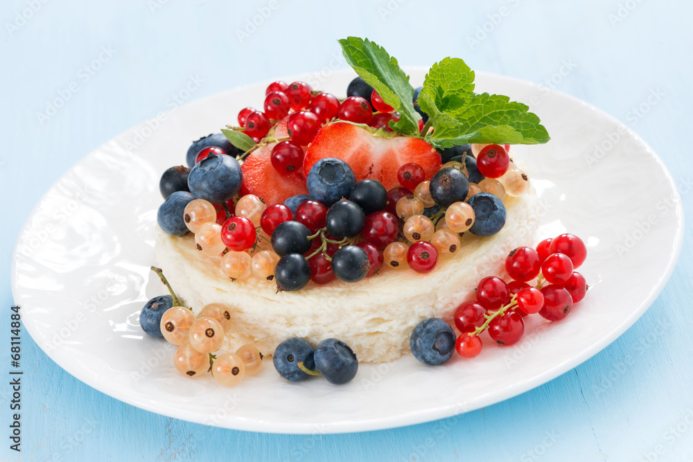 mini cheesecake with fresh berries on a blue background mini cheesecake with fresh berries on a blue background