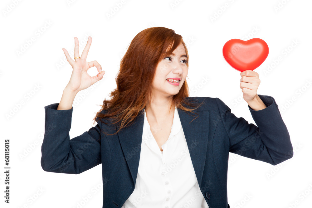 Asian businesswoman show OK sign look at a heart Asian businesswoman show OK sign look at a heart