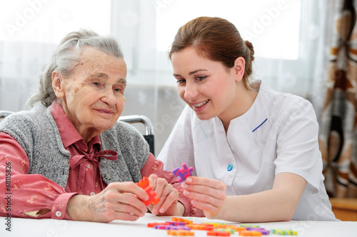 Senior woman with her elder care nurse photo