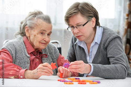 Senior woman with her elder care nurse photo