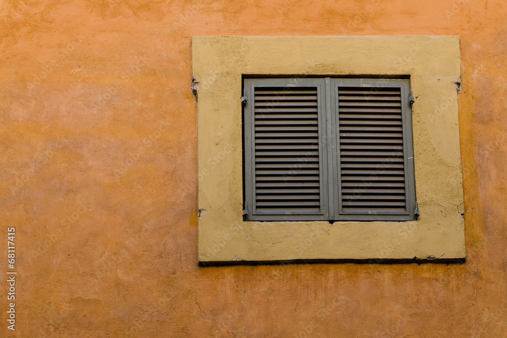 old facade with closed window, Italy