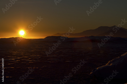 islands and waters of the Antarctic winter evening at sunset