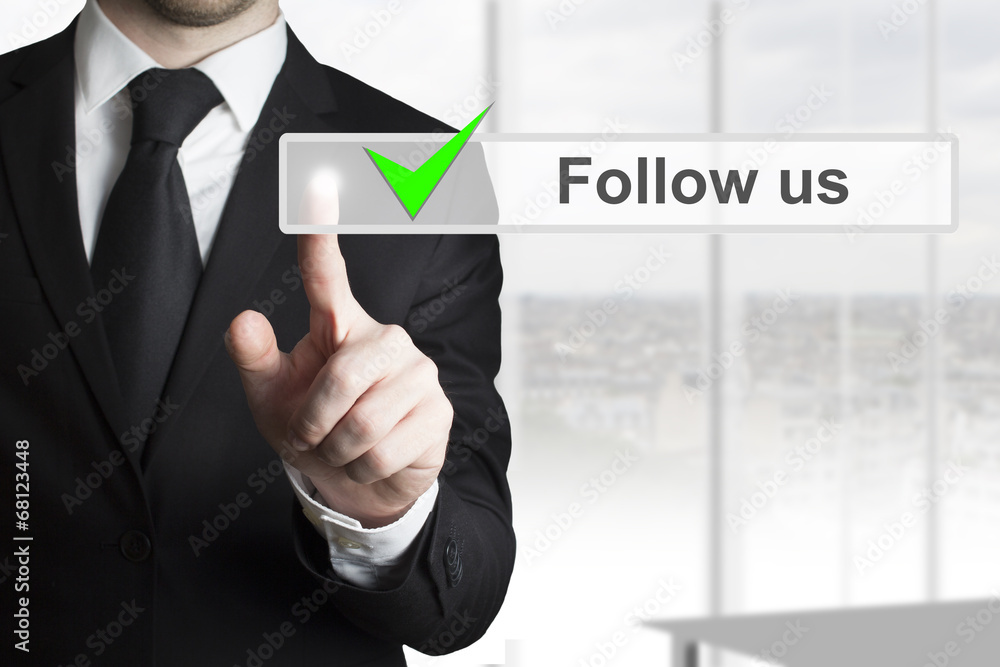 Fototapeta premium businessman pressing touchscreen follow us