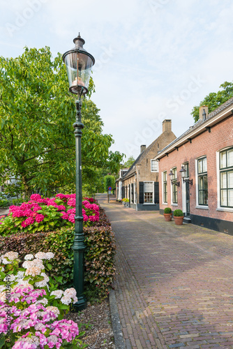 Old street with historic houses in a Dutch village