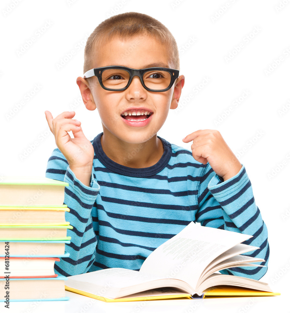Young boy is daydreaming while reading book Young boy is daydreaming while reading book