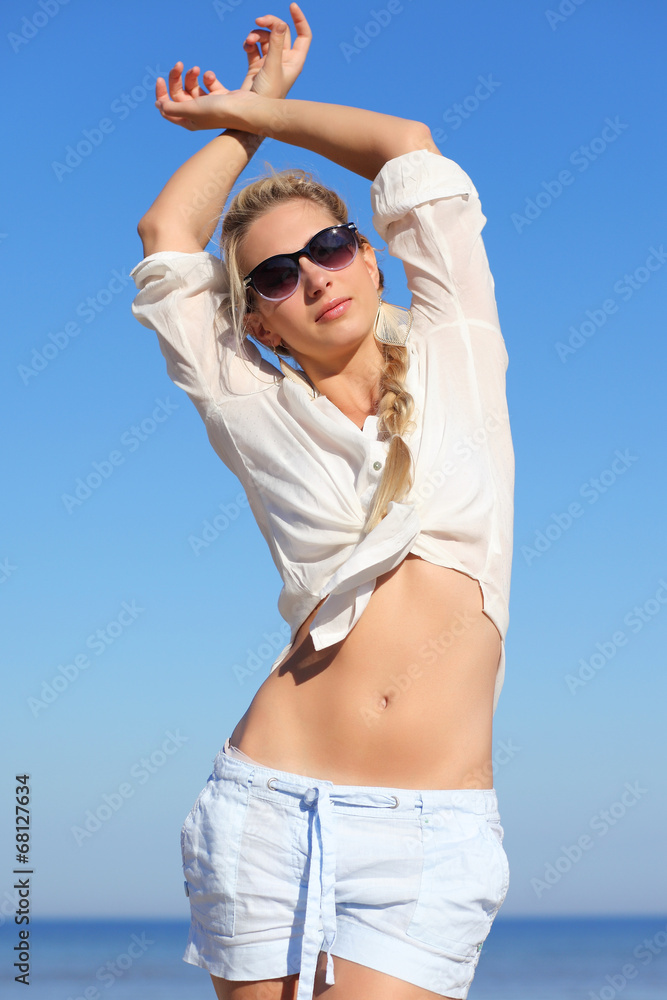 girl in sunglasses on background of sky