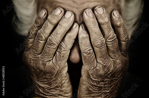 Closeup portrait depressed old woman covering her face with hand