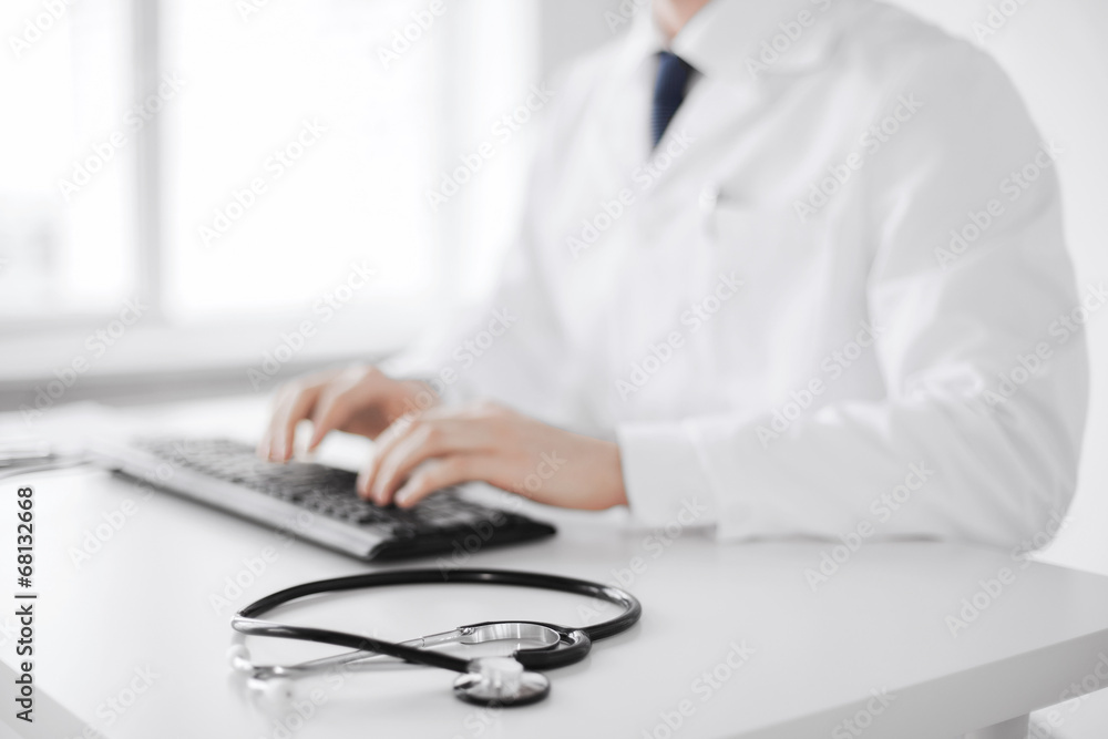 male doctor typing on the keyboard male doctor typing on the keyboard