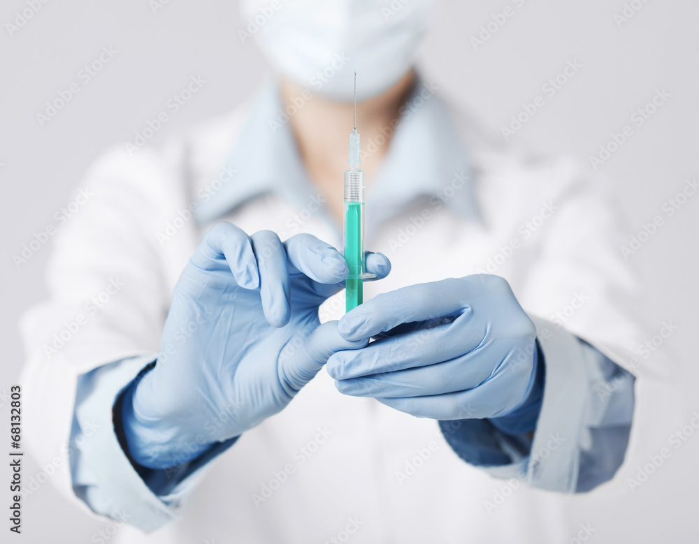 female doctor holding syringe with injection female doctor holding syringe with injection
