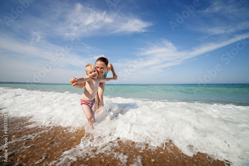 Photography Mother and son play in the waves