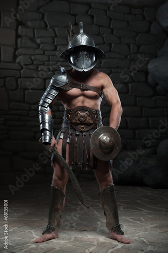 Gladiator in helmet and armour holding sword