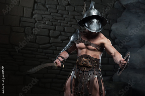 Obraz na płótnie Gladiator in helmet and armour holding sword
