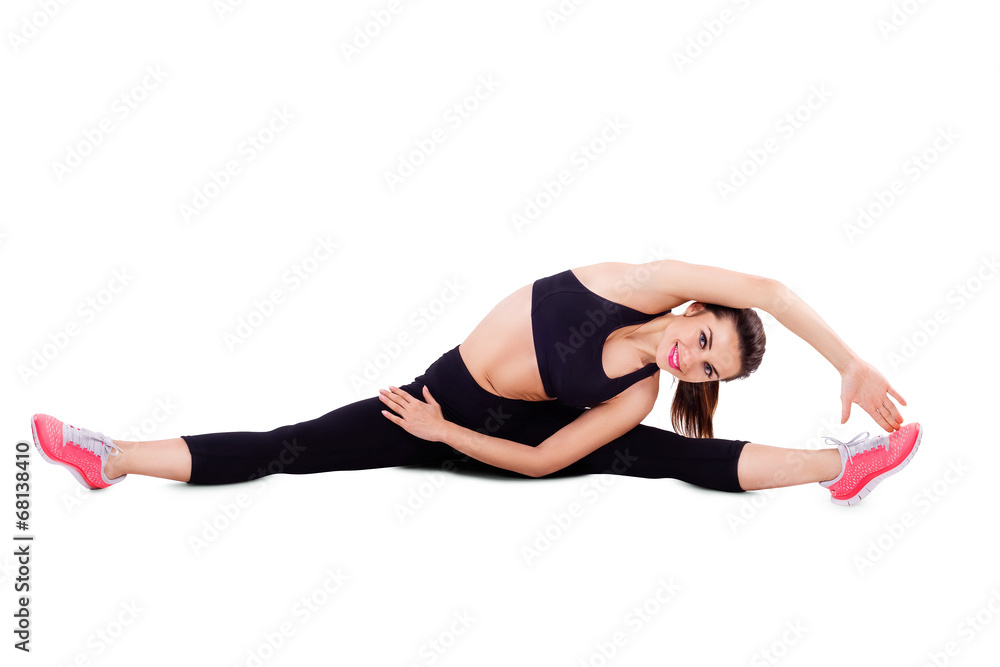Beautiful woman dressed for fitness doing stretching exercises Beautiful woman dressed for fitness doing stretching exercises