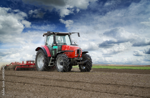 Preparing land for sowing at spring  farmer in tractor