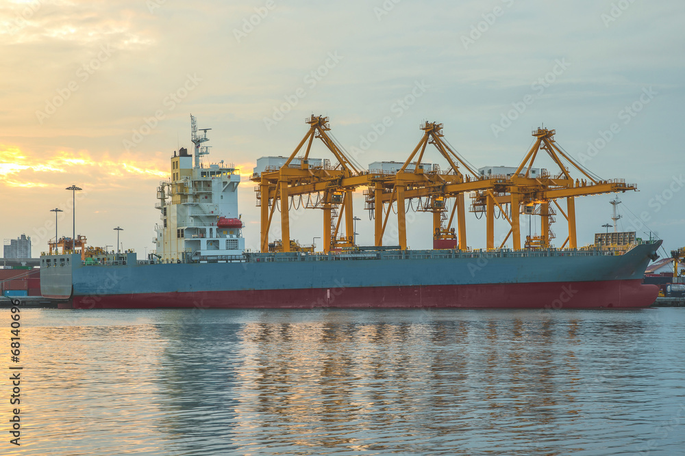 Shipping port with crane for container uploading at dusk Shipping port with crane for container uploading at dusk