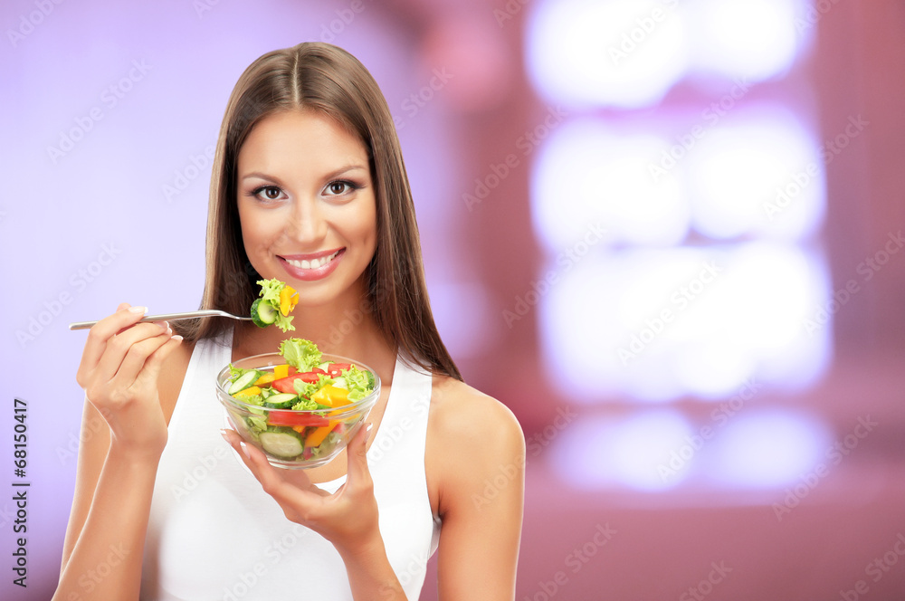 Beautiful young woman with salad on interior background Beautiful young woman with salad on interior background