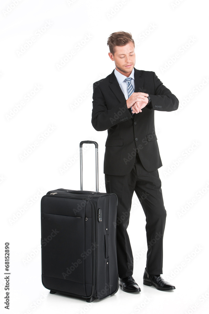 handsome guy standing with luggage in suit. handsome guy standing with luggage in suit.