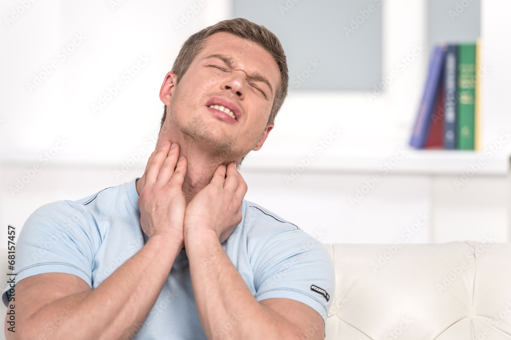 Portrait of handsome male with pain in throat.