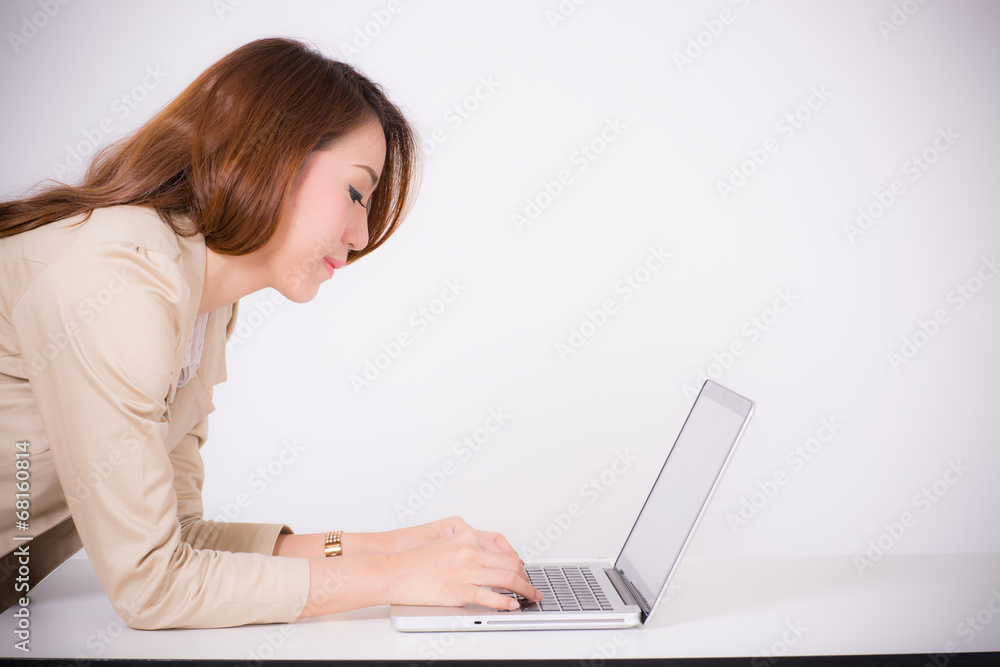 Portrait of a young business woman using laptop at office Portrait of a young business woman using laptop at office